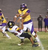 Lemoore's Isaiah Morales nails Tulare's quarterback as he released the ball in Friday night's Tiger victory.